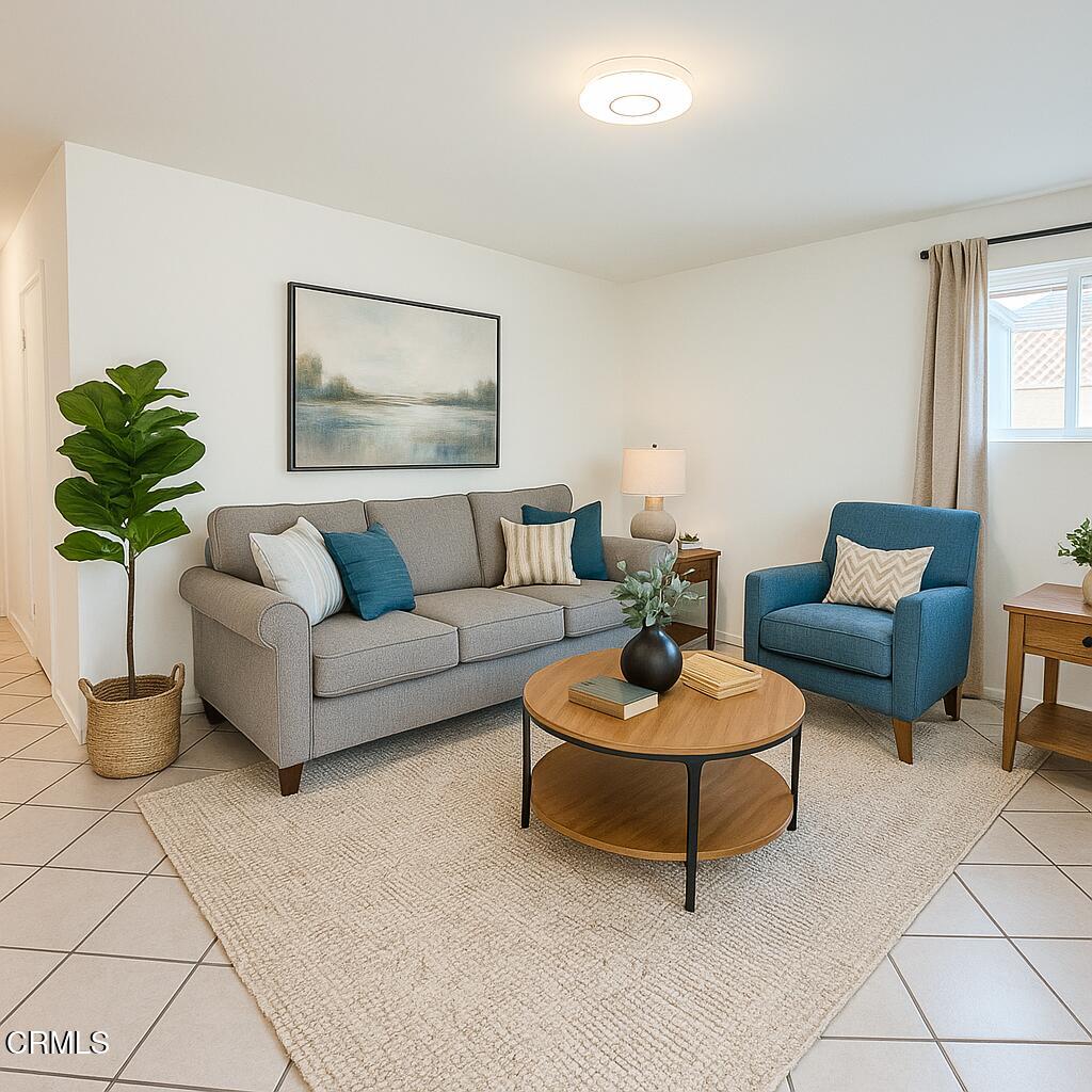a living room with furniture and a potted plant