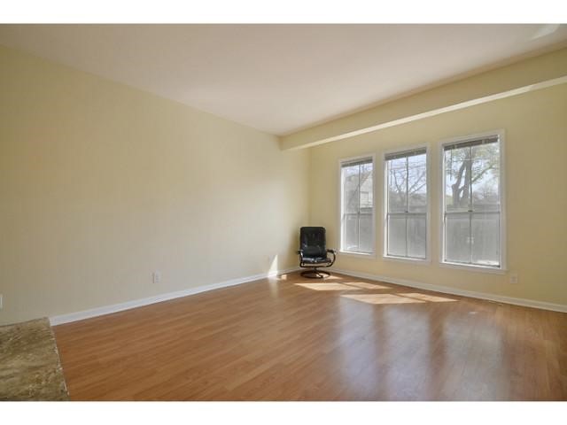 2529 Rio Grande Street, Unit 63 Austin, TX 78705 - Photo 2 of 5 a view of an empty room with wooden floor and a window