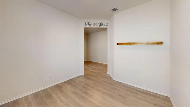 a view of a livingroom with a ceiling fan and window