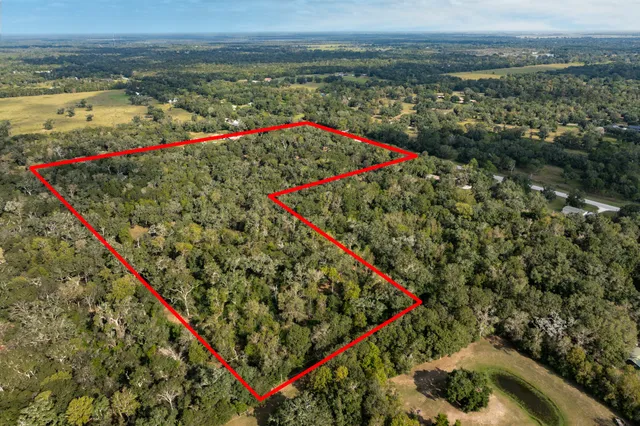 an aerial view of a houses with yard