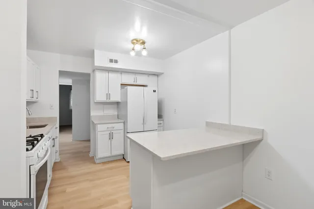 a kitchen with a refrigerator a sink and a stove