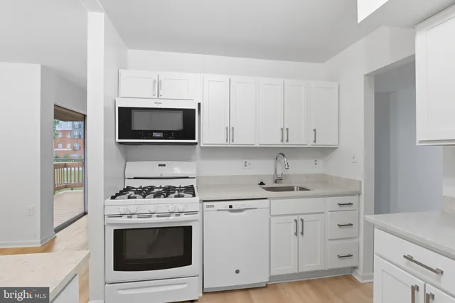 a kitchen with cabinets appliances and a counter space