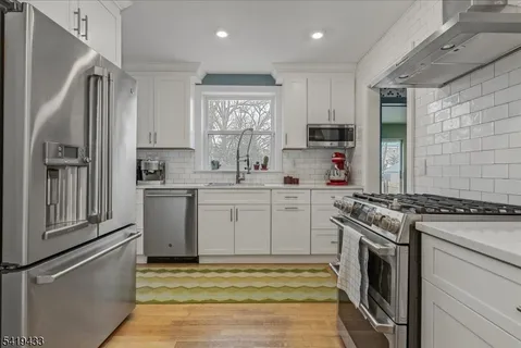 a kitchen with a stove sink and refrigerator