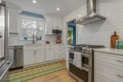 a kitchen with a stove oven and sink