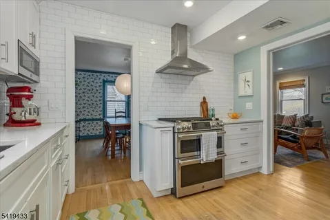 a kitchen with stove and cabinets