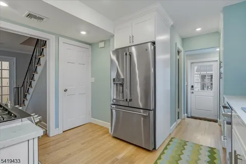 a view of a refrigerator in kitchen and wooden floor