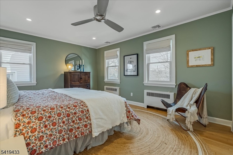 4 Rynda Road Maplewood, NJ 07040 - Photo 21 of 34 a bedroom with a bed and wooden floor