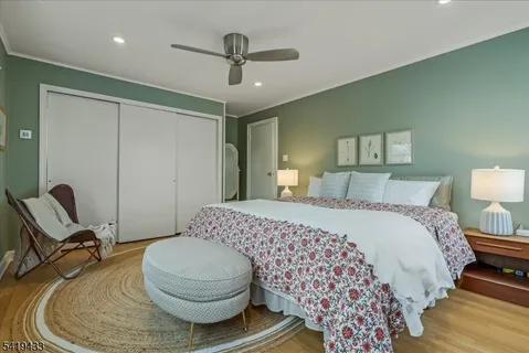 a bedroom with a bed and chair