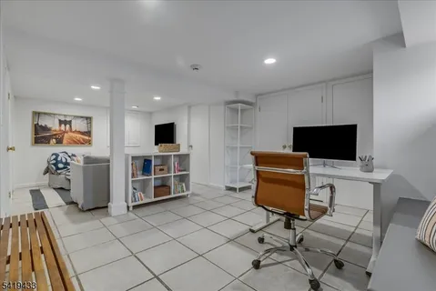 a view of a livingroom with furniture and a flat screen tv