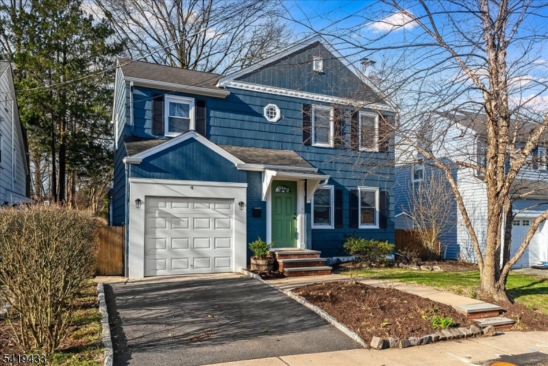4 Rynda Road Maplewood, NJ 07040 - Photo 3 of 34 a view of a brick house with large windows and a large tree