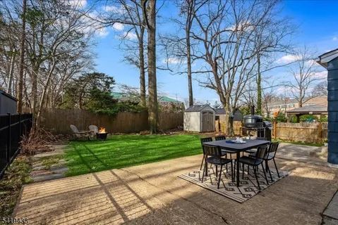 a view of a backyard with sitting area