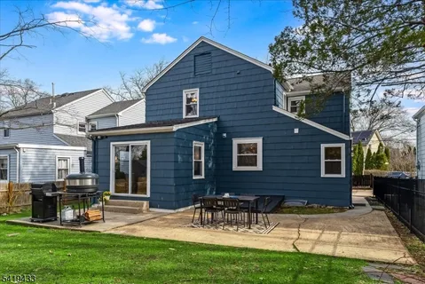 a view of a house with a yard and sitting area
