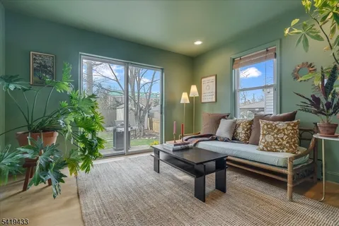 a living room with furniture and a potted plant