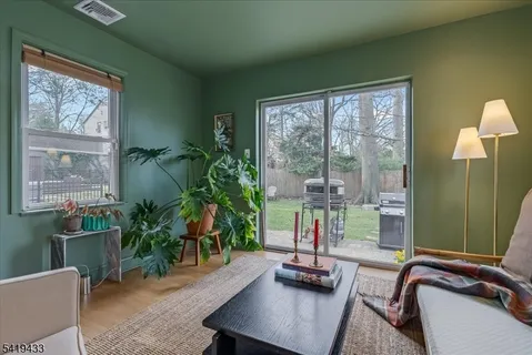 a work room with furniture and a potted plant