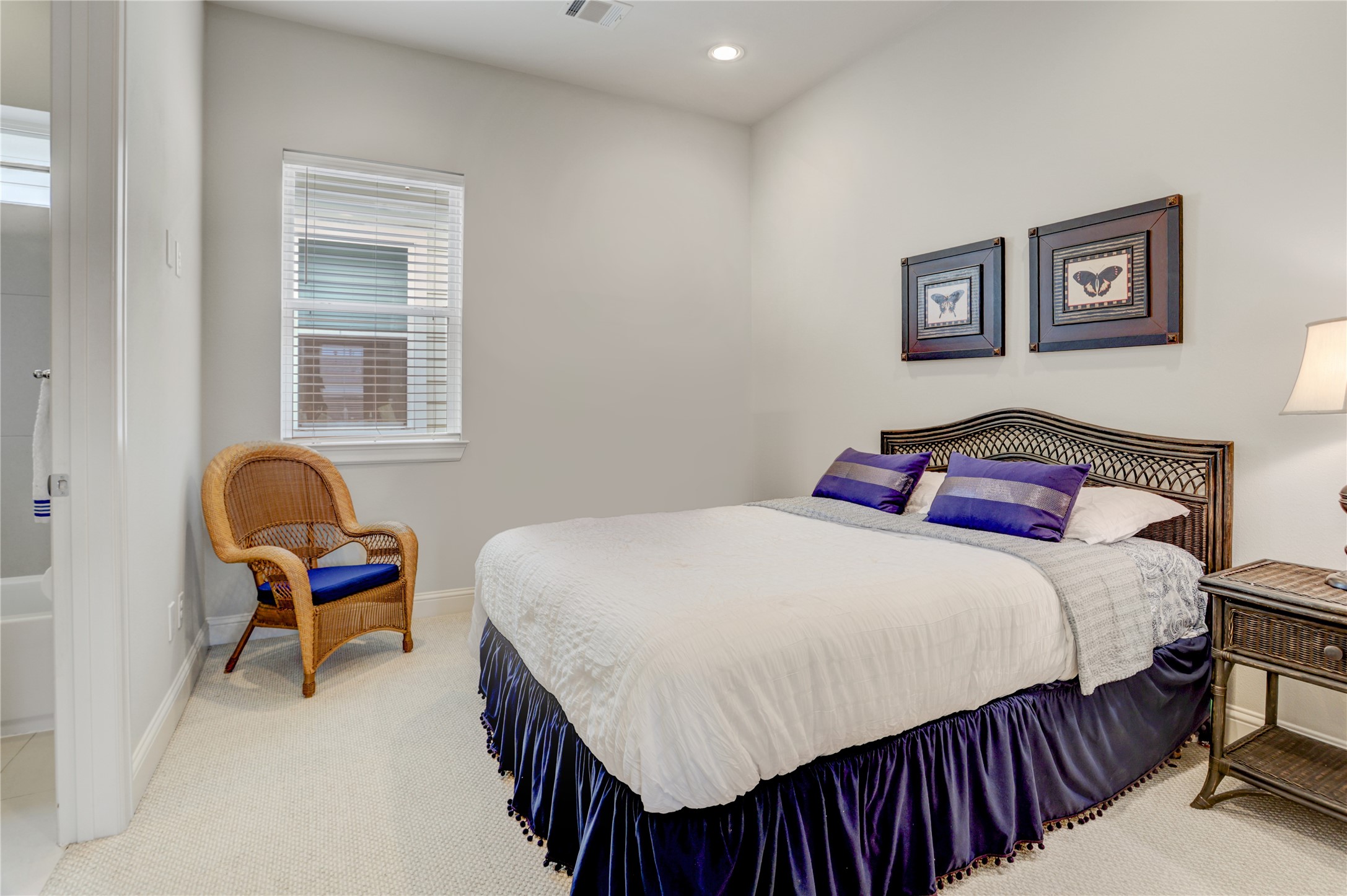 5637 Kiam Street, Unit D Houston, TX 77007 - Photo 11 of 12 a bedroom with a bed a dresser and a window