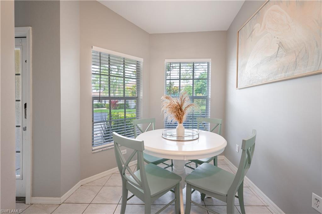 367 Dover Place, Unit 1002 Naples, FL 34104 - Photo 11 of 31 a view of a dining room with furniture and window