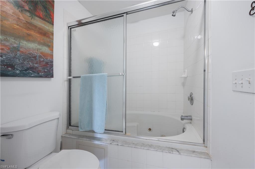 367 Dover Place, Unit 1002 Naples, FL 34104 - Photo 15 of 31 a bathroom with a shower and toilet