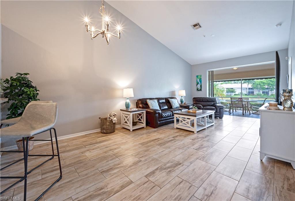 367 Dover Place, Unit 1002 Naples, FL 34104 - Photo 16 of 31 a living room with furniture and a large window
