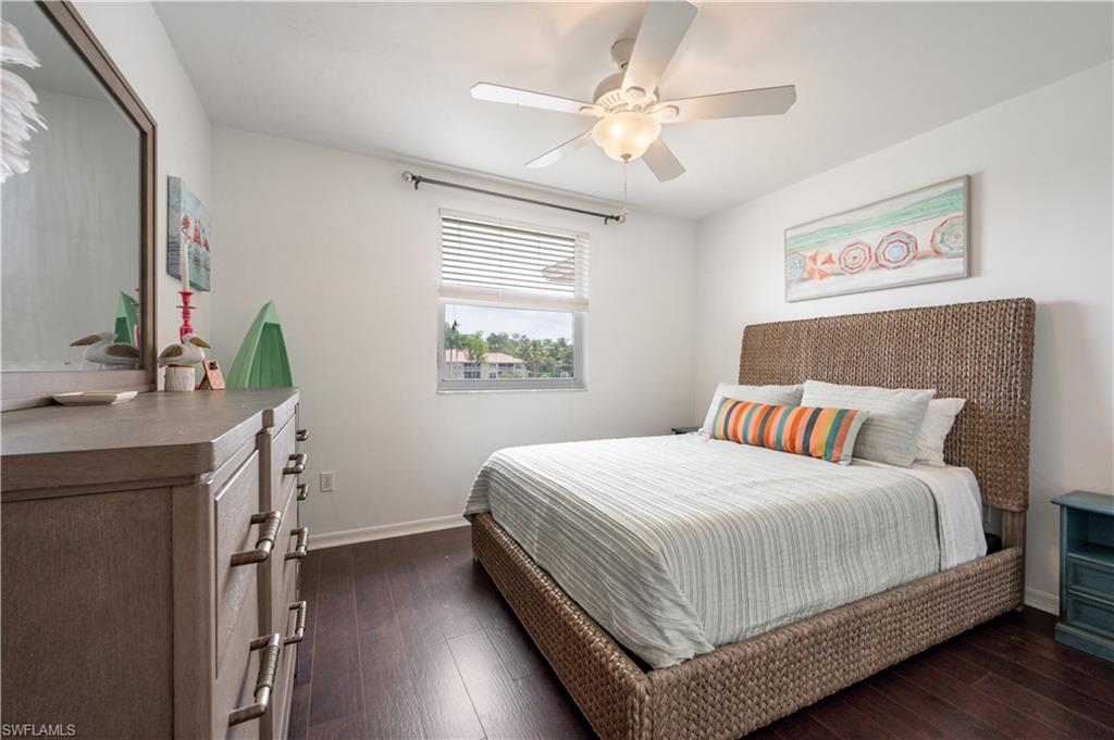 367 Dover Place, Unit 1002 Naples, FL 34104 - Photo 20 of 31 a bedroom with a large bed a chandelier and a window