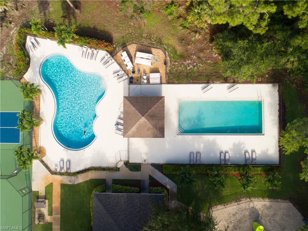 367 Dover Place, Unit 1002 Naples, FL 34104 - Photo 31 of 31 an aerial view of a house with garden space pool seating area and yard