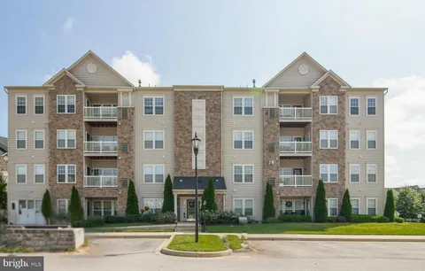 a front view of a residential apartment building with a yard