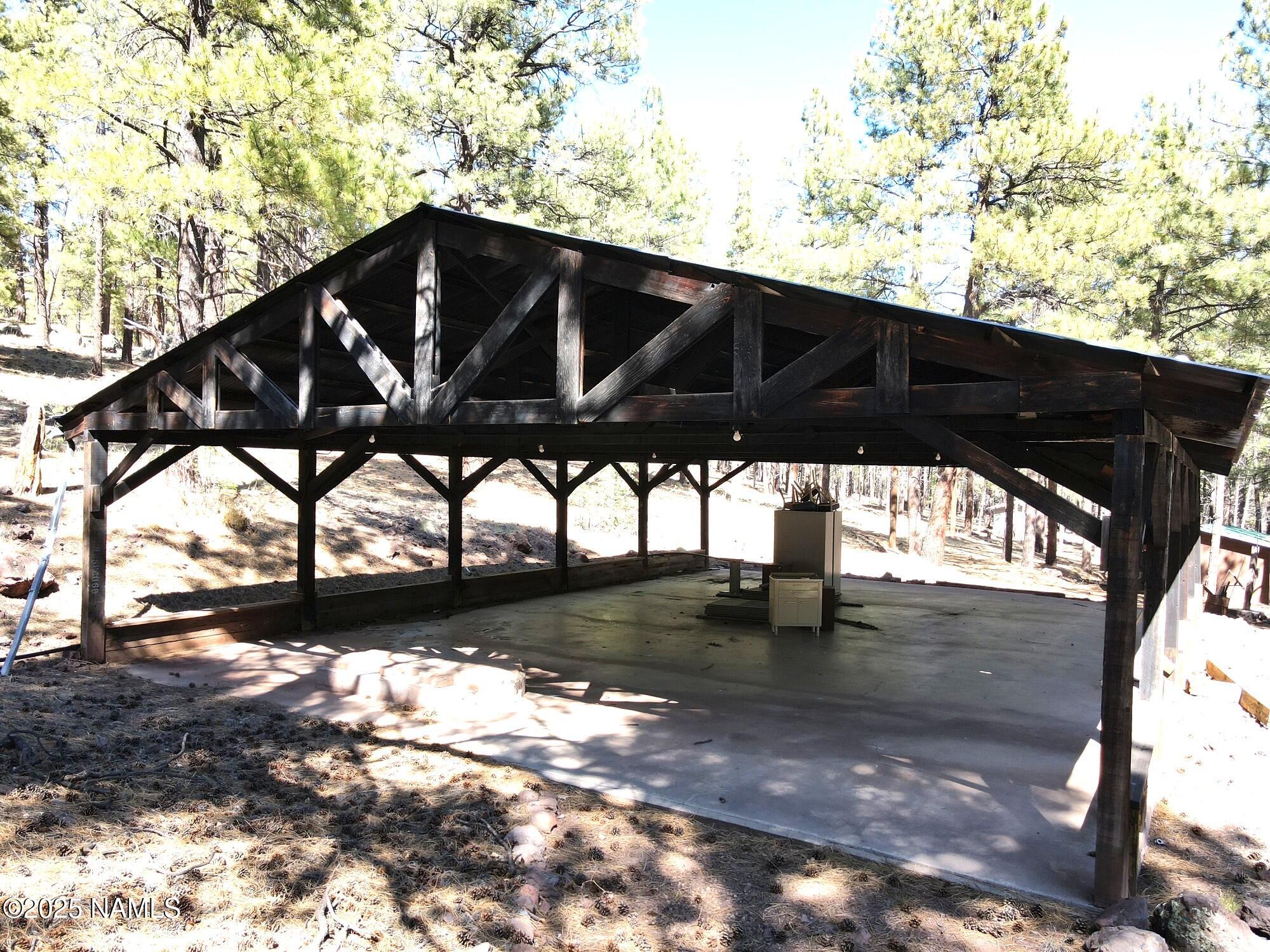 7145 East 4h Club Camp Road Williams, AZ 86046 - Photo 2 of 35 a black and white building with trees in the background