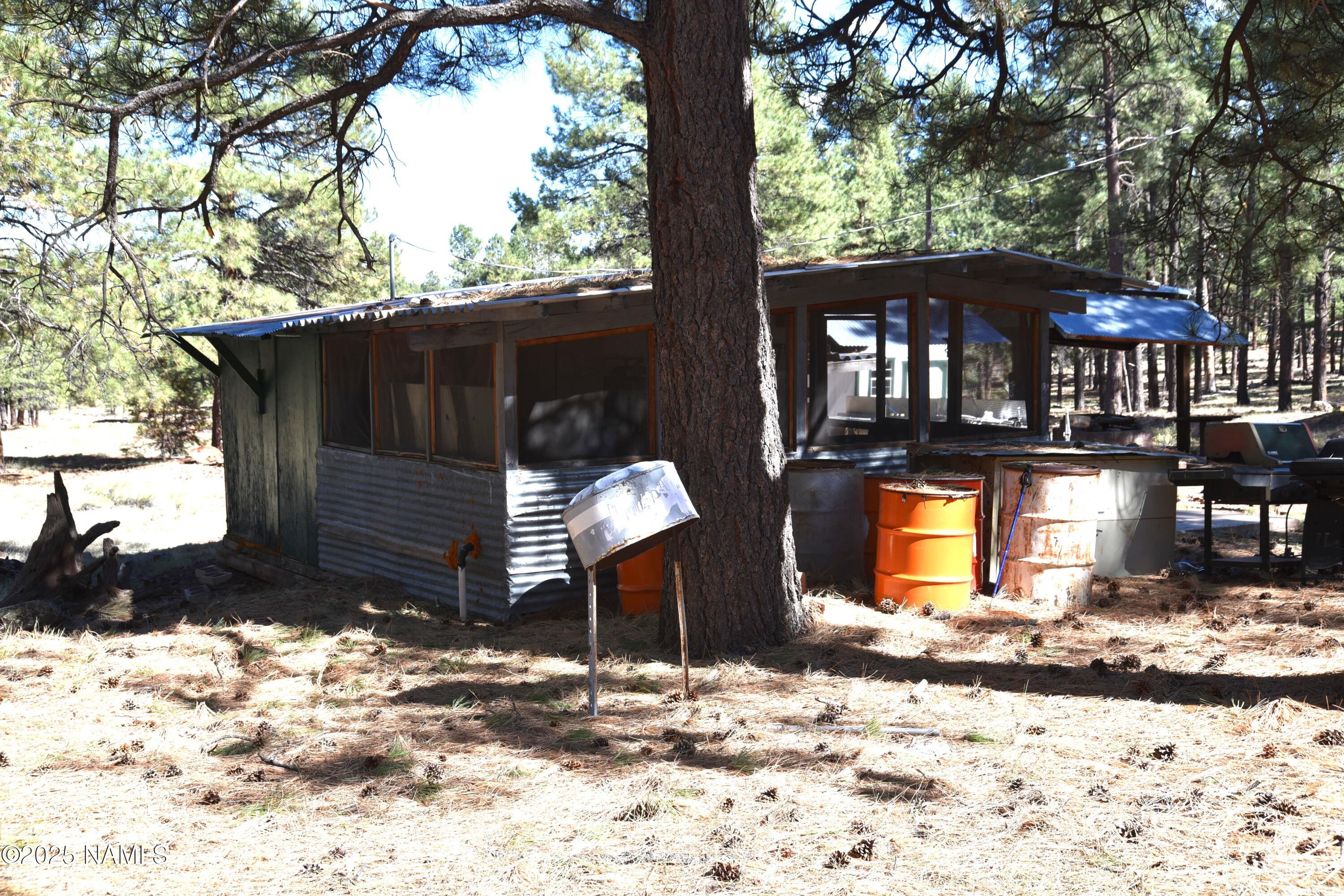 7145 East 4h Club Camp Road Williams, AZ 86046 - Photo 27 of 35 a front view of a house with a yard covered in snow