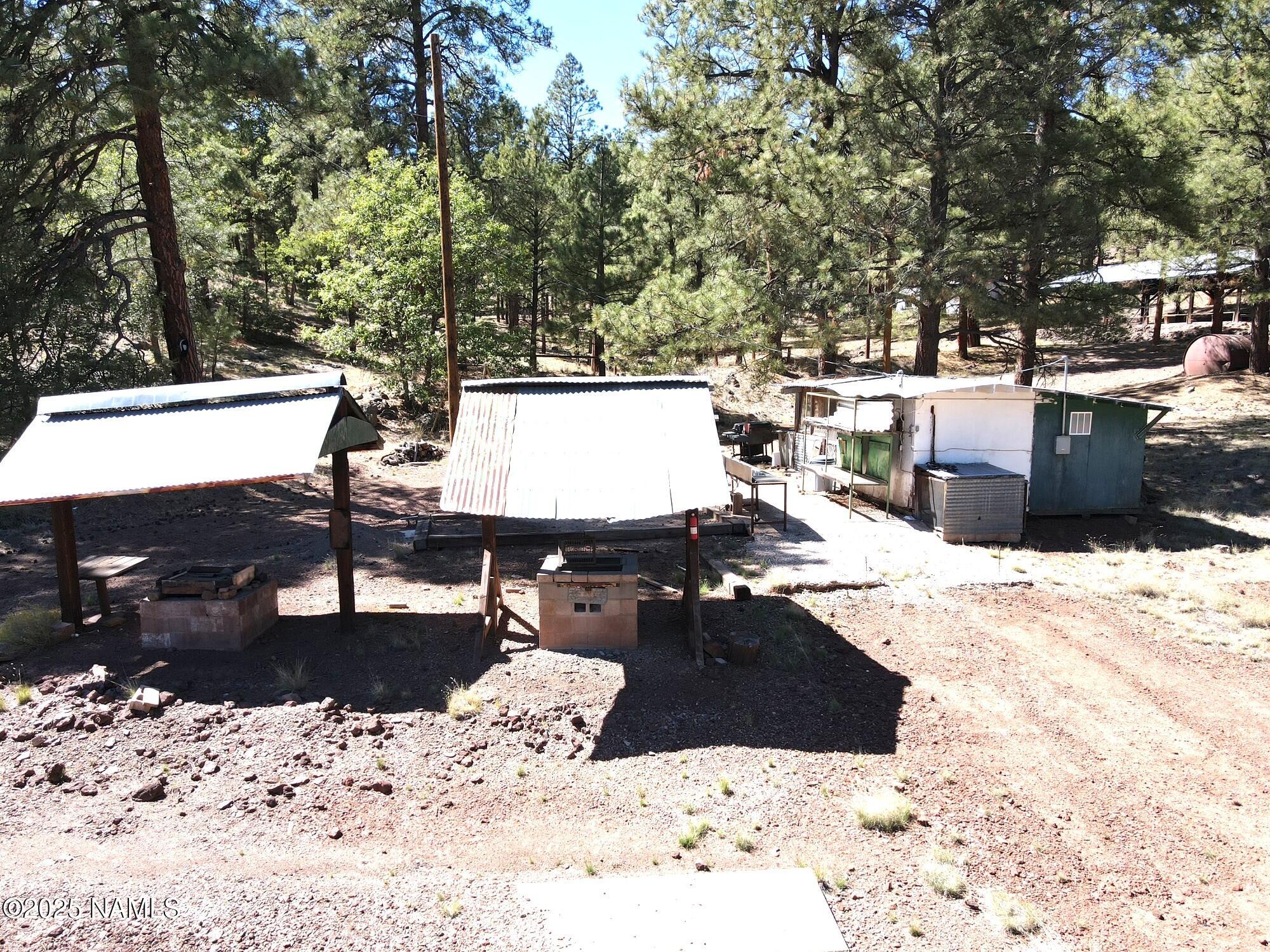 7145 East 4h Club Camp Road Williams, AZ 86046 - Photo 29 of 35 a view of a patio with a wooden fence