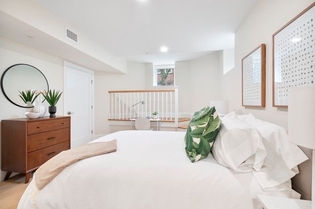 a bedroom with a bed and a dresser