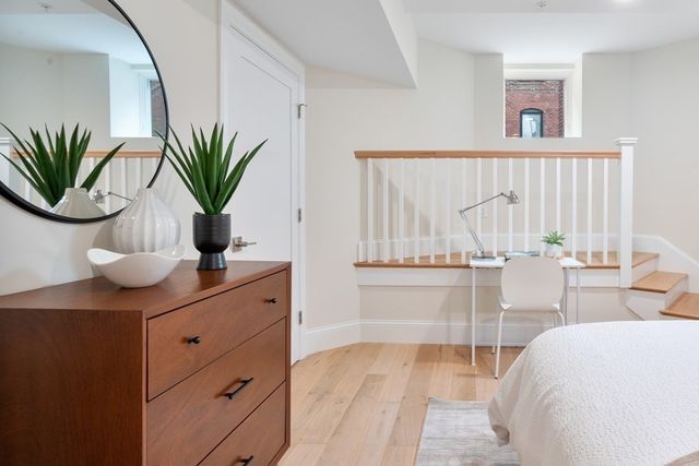 a living room with furniture and potted plant