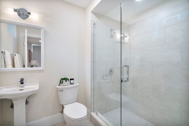 a bathroom with a toilet sink and shower