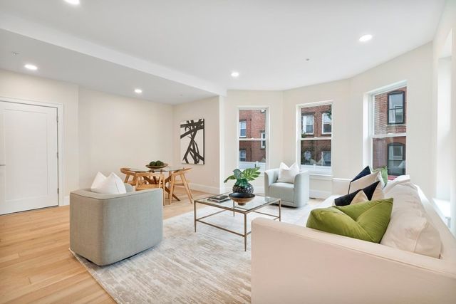 a living room with furniture and windows
