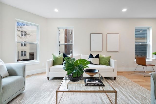 a living room with furniture or couch and a potted plant