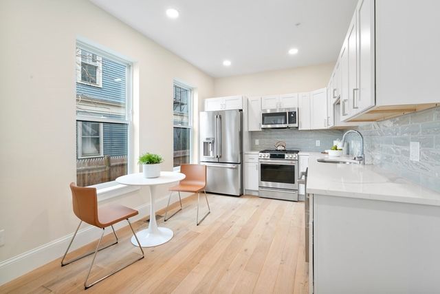 a kitchen with stainless steel appliances granite countertop a refrigerator sink and cabinets