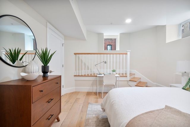 a living room with furniture and potted plant
