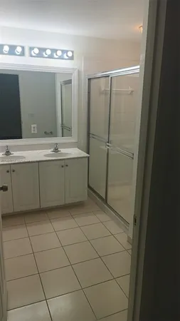 a bathroom with a granite countertop sink and mirror