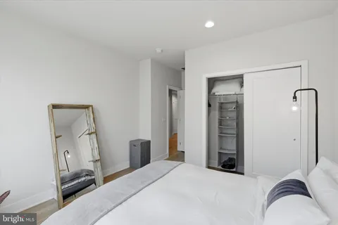a bedroom with a bed and a mirror