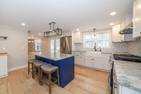 a kitchen with sink cabinets and wooden floor