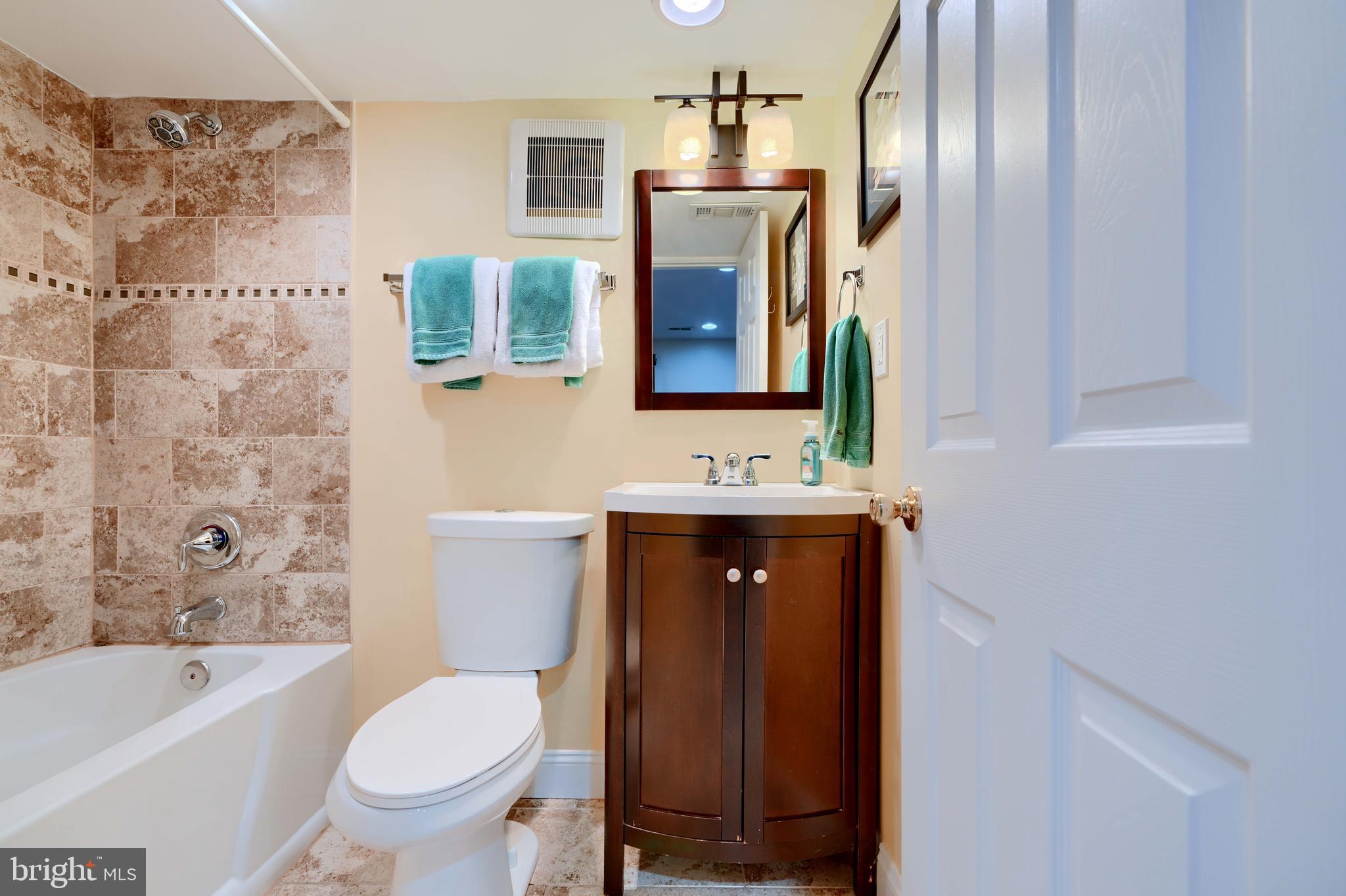 8232 Scotts Level Road Baltimore, MD 21208 - Photo 50 of 69 a bathroom with a bathtub sink mirror vanity and toilet