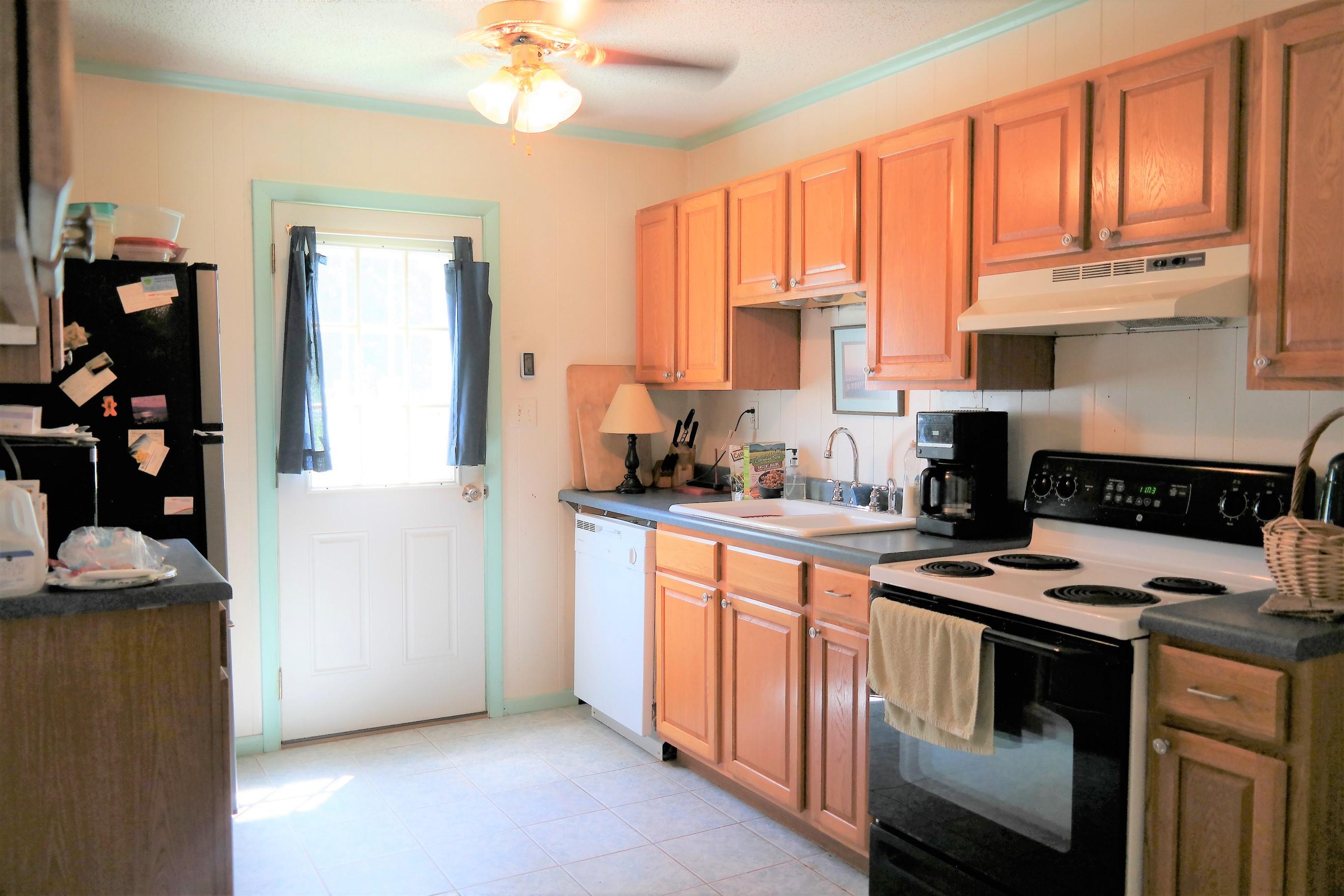1824 Bay Grove Road Freeport, FL 32439 - Photo 25 of 51 a kitchen with stainless steel appliances granite countertop a stove a sink and a refrigerator