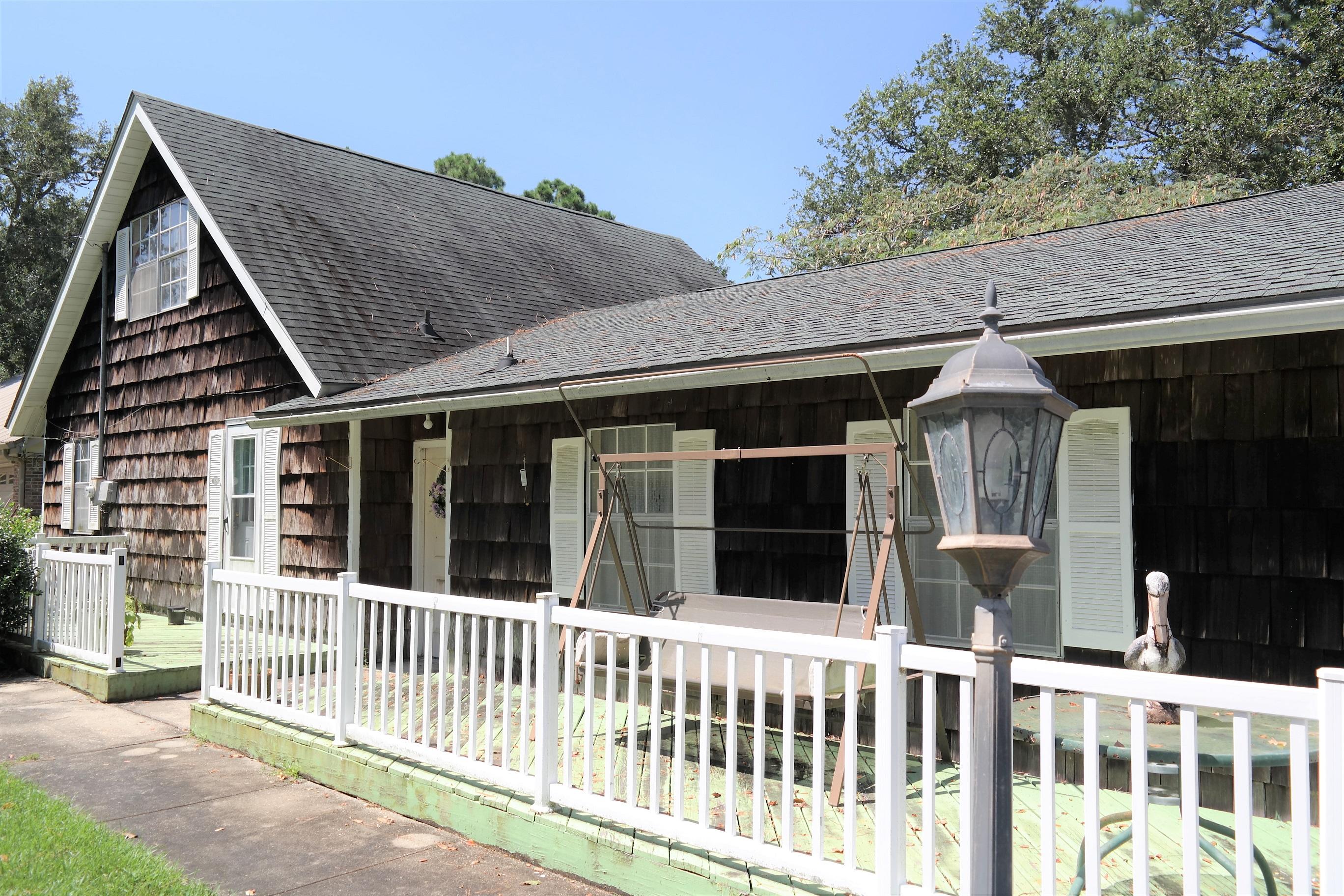 1824 Bay Grove Road Freeport, FL 32439 - Photo 38 of 51 a porch with a bench next to a yard