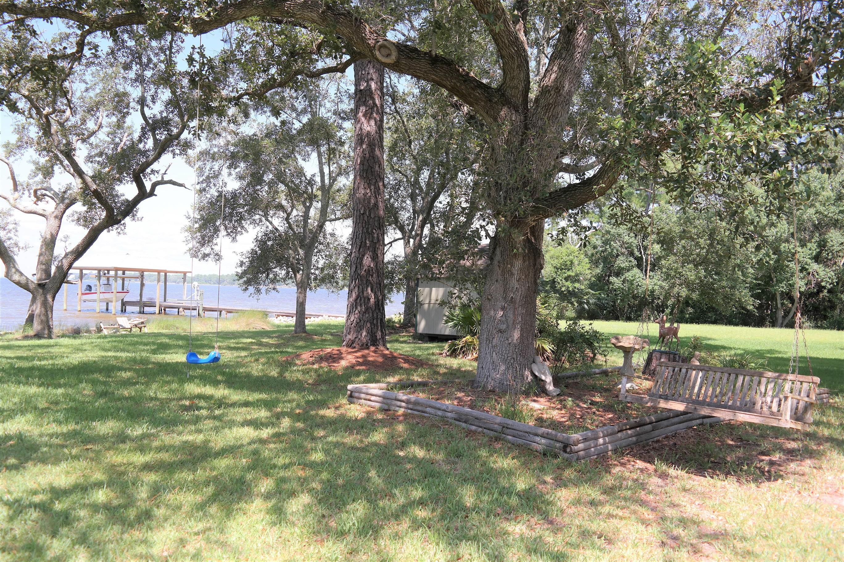 1824 Bay Grove Road Freeport, FL 32439 - Photo 51 of 51 a view of outdoor space with deck and trees