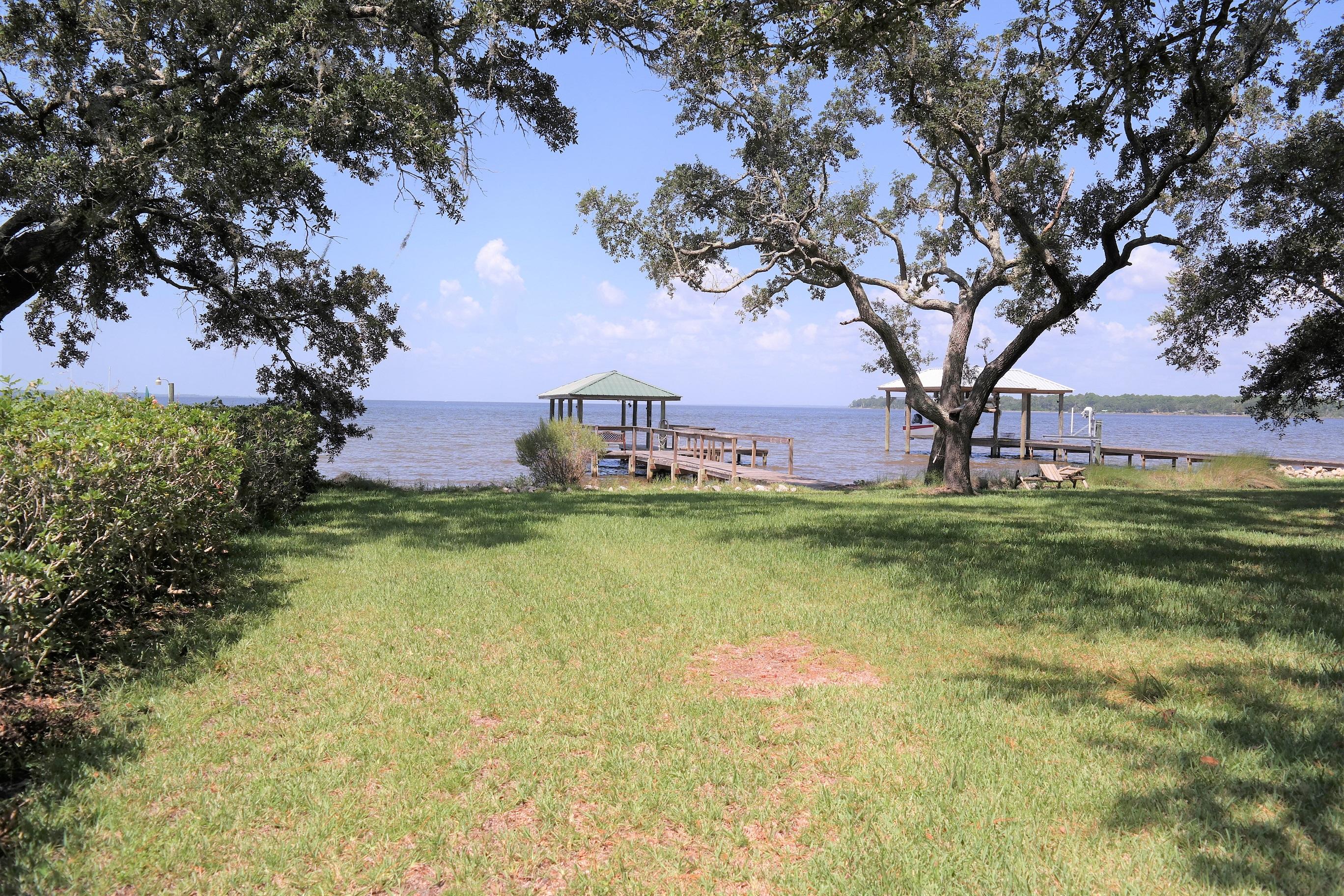 1824 Bay Grove Road Freeport, FL 32439 - Photo 8 of 51 a swimming pool with trees in the background