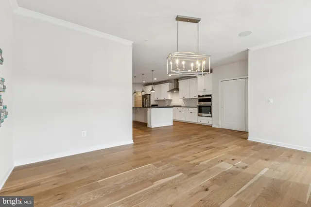 a view of a kitchen with wooden floor and a kitchen