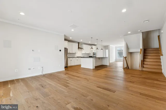 a view of kitchen with kitchen island microwave and stove