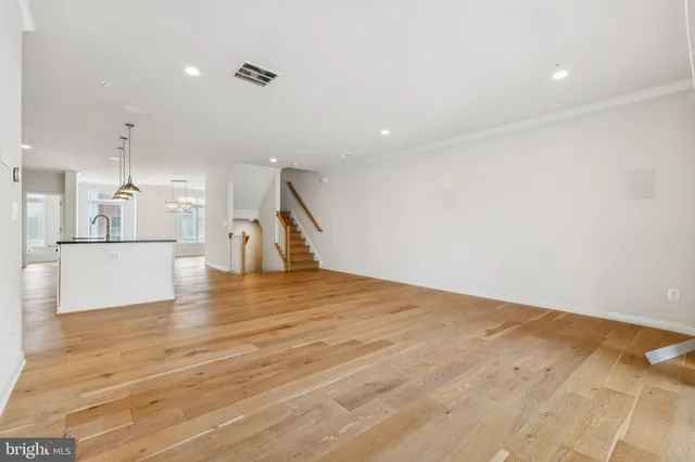 a view of a kitchen with a sink and wooden floor