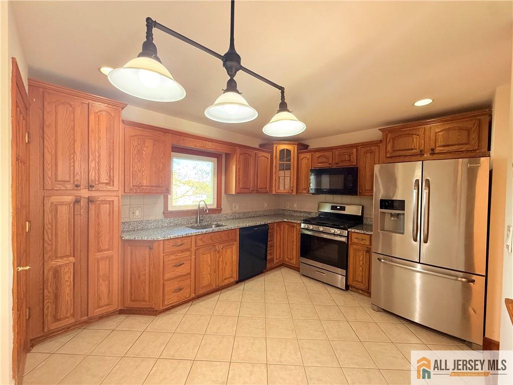 10 Hamilton Avenue Edison, NJ 08820 - Photo 6 of 10 a kitchen with stainless steel appliances granite countertop a refrigerator a sink dishwasher a stove and a refrigerator
