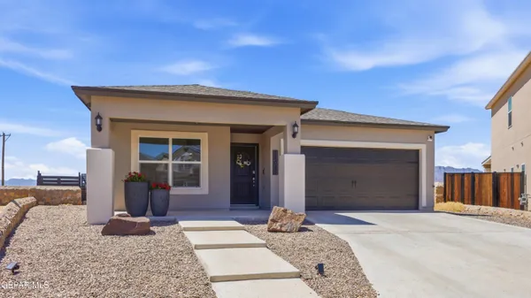 a kitchen with stainless steel appliances kitchen island granite countertop a dining table chairs and a refrigerator