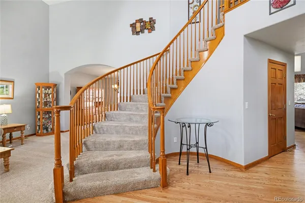 a view of entryway and hall with wooden floor