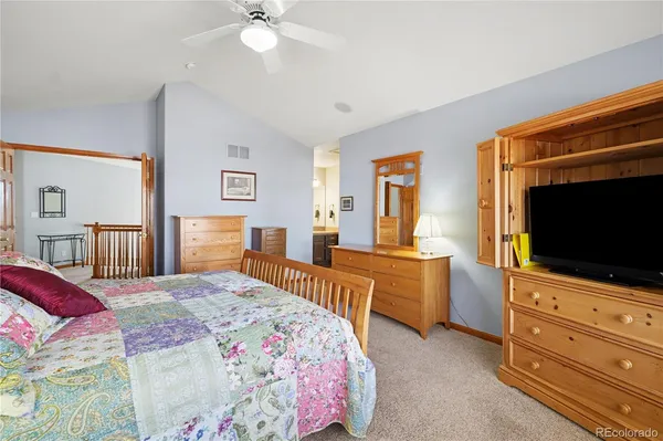 a bedroom with a large bed and a flat screen tv
